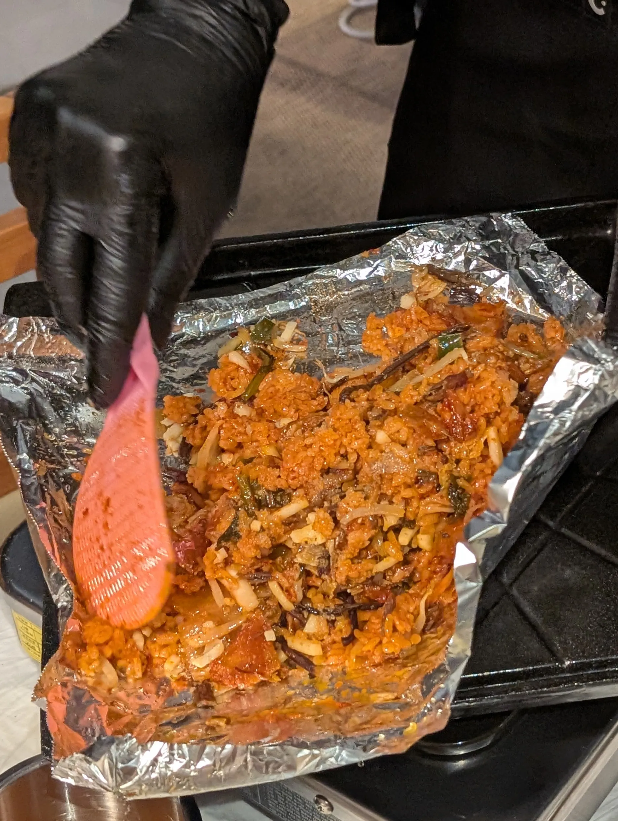 Staff preparing kimchi fried rice at Bae Sik Dang Singapore
