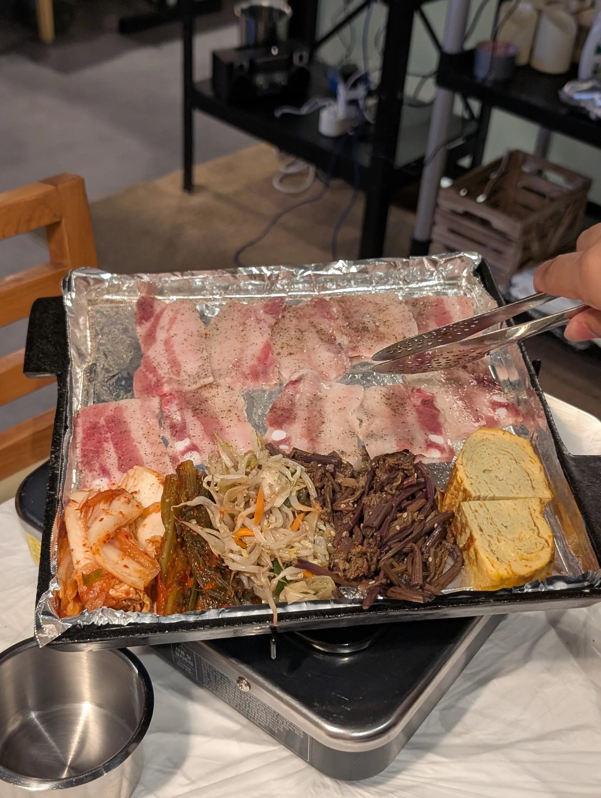 Frozen Jeju pork belly being grilled at Bae Sik Dang Singapore