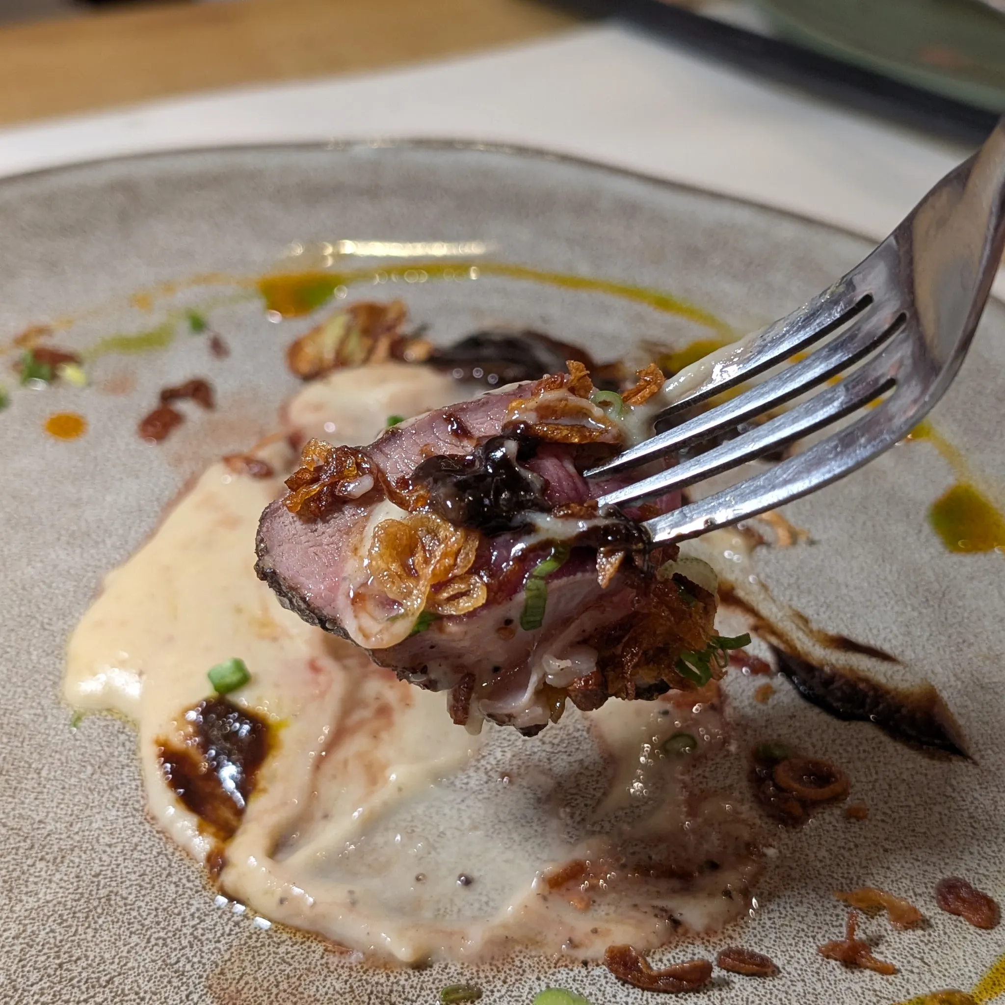 A close-up shot of Grilled Australian Mountain Lamb with Chinese Yam Purée, Black Garlic Purée, Fried Garlic from Psychotic Operator, Selangor, Malaysia