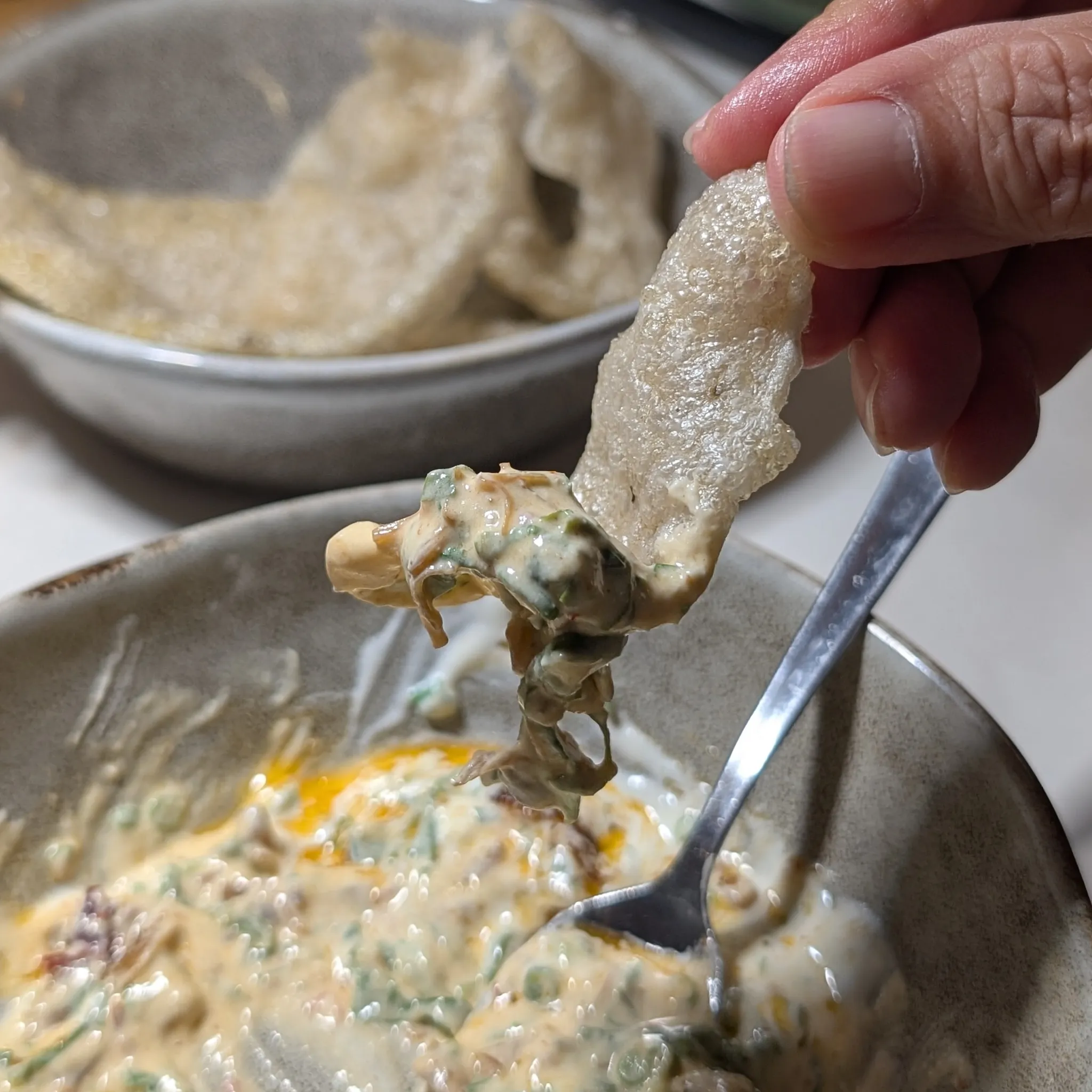 A close-up shot of Yogurt XO Dip with Garlic Yogurt Cream, XO Sauce, Fish Crackers from Psychotic Operator, Selangor, Malaysia