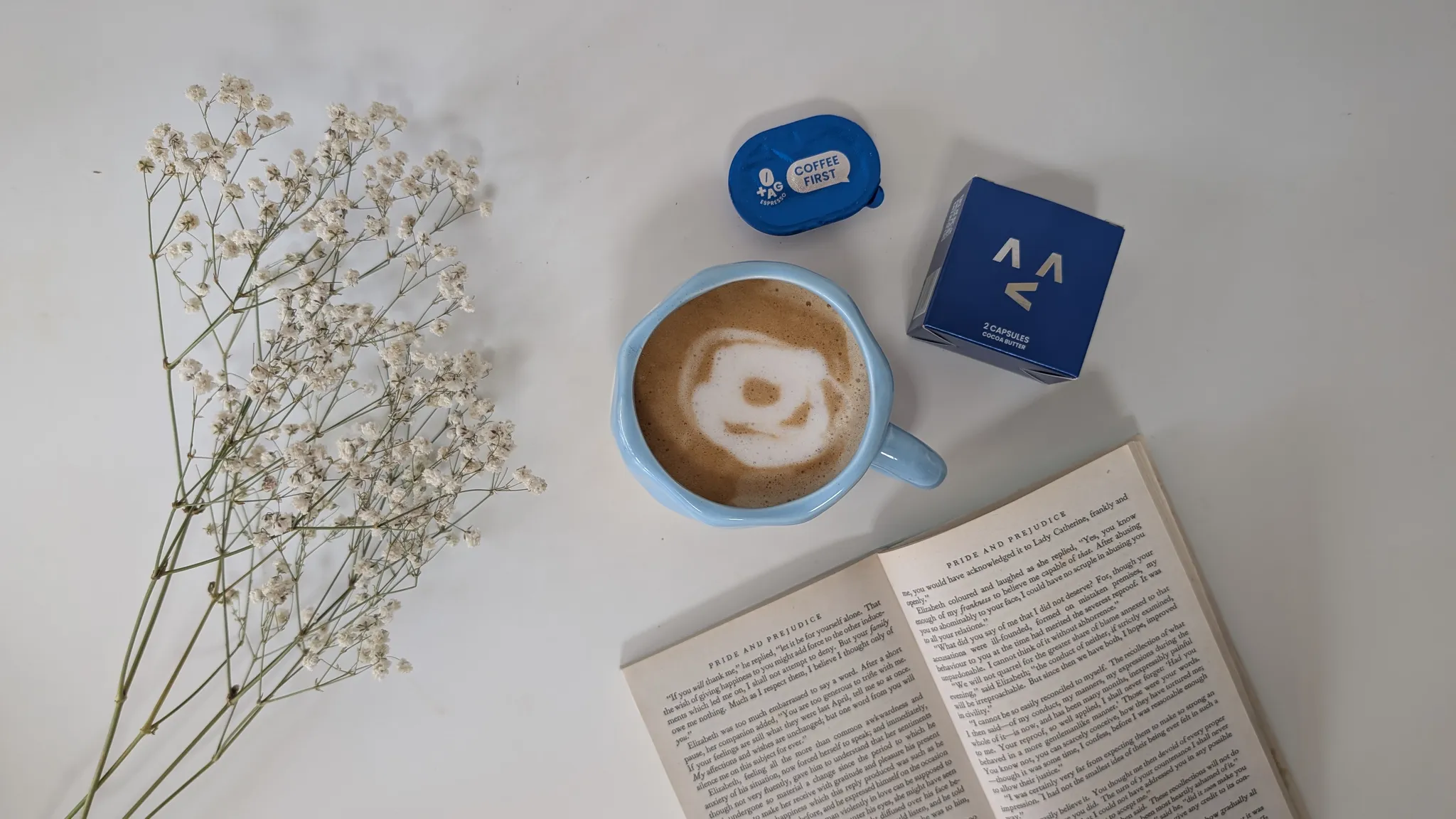 Afternoon coffee break with a book and hot latte made with TAG Espresso