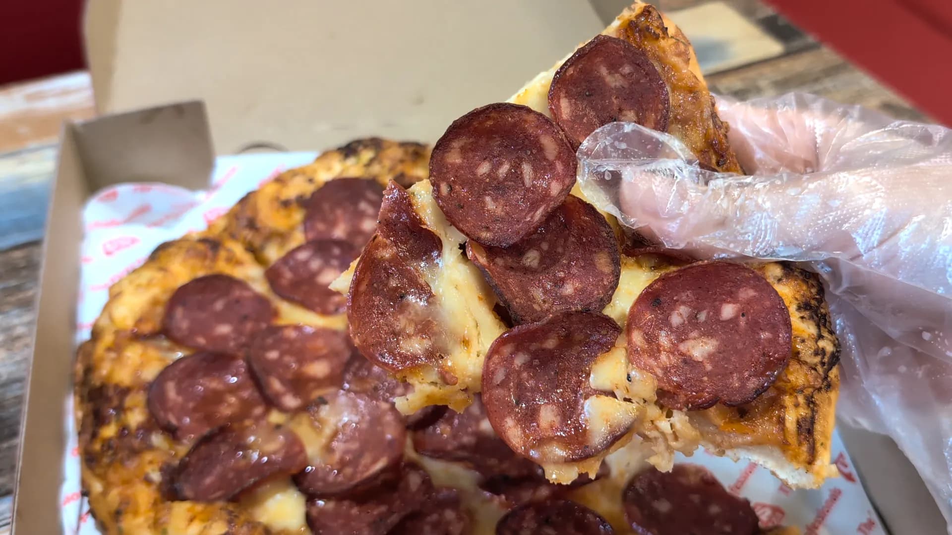 A close-up shot of one slice of US Favourite Beef Original Hand-Tossed Pizza from US Pizza in Singapore