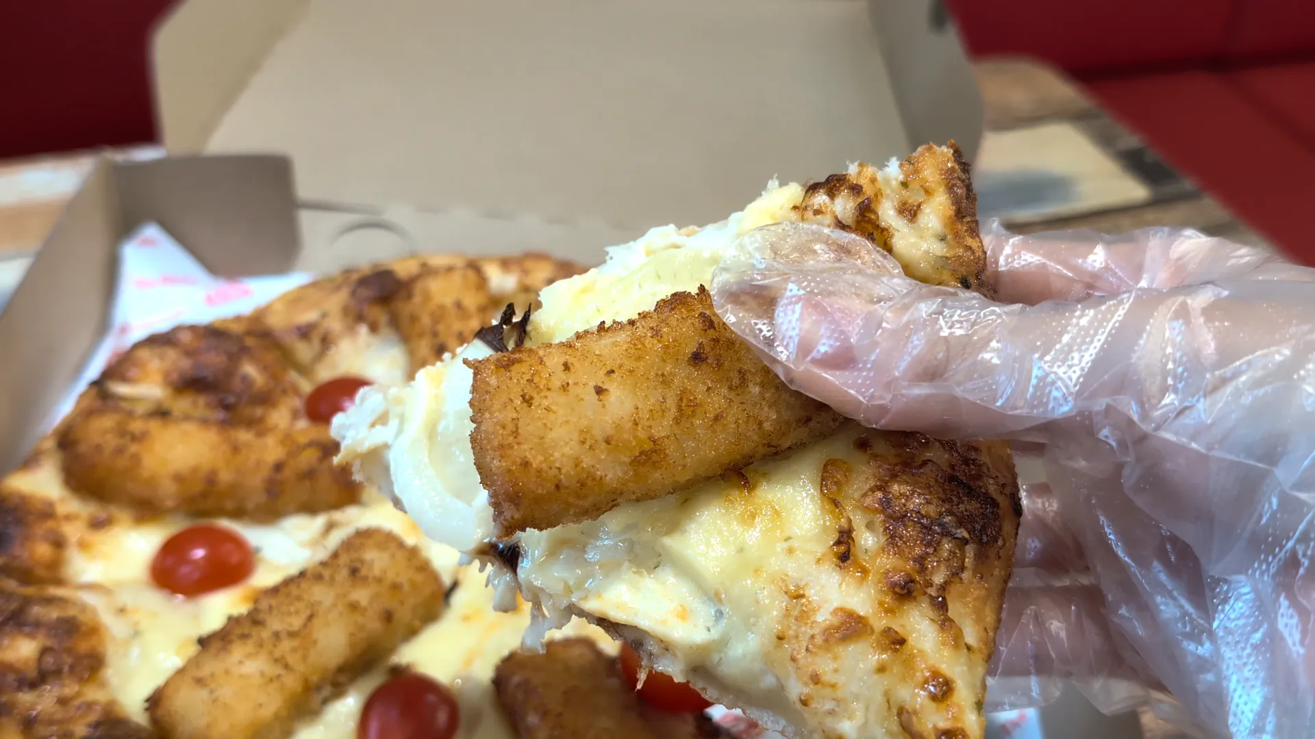 A close-up shot of one slice of Fish 'N' Chip Original Hand-Tossed Pizza from US Pizza in Singapore